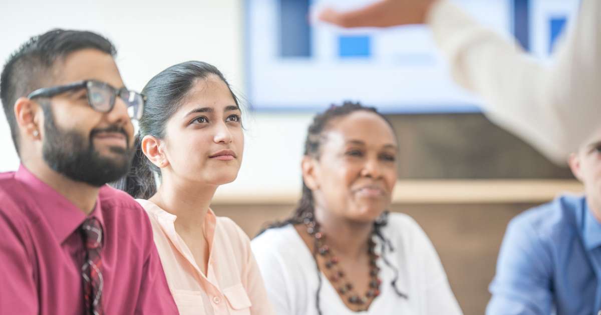 Adultes apprenants en train d'écouter leur formateur